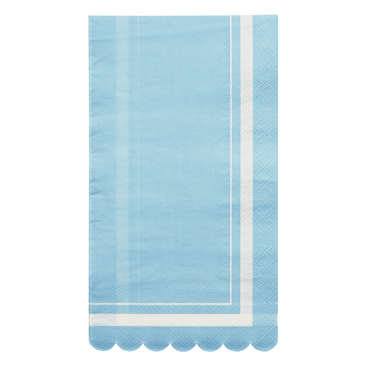Light blue napkin with white scalloped edge on a white background