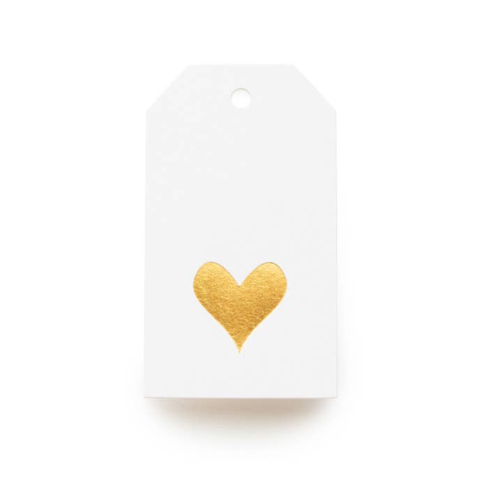White gift tag with a gold heart on a white background