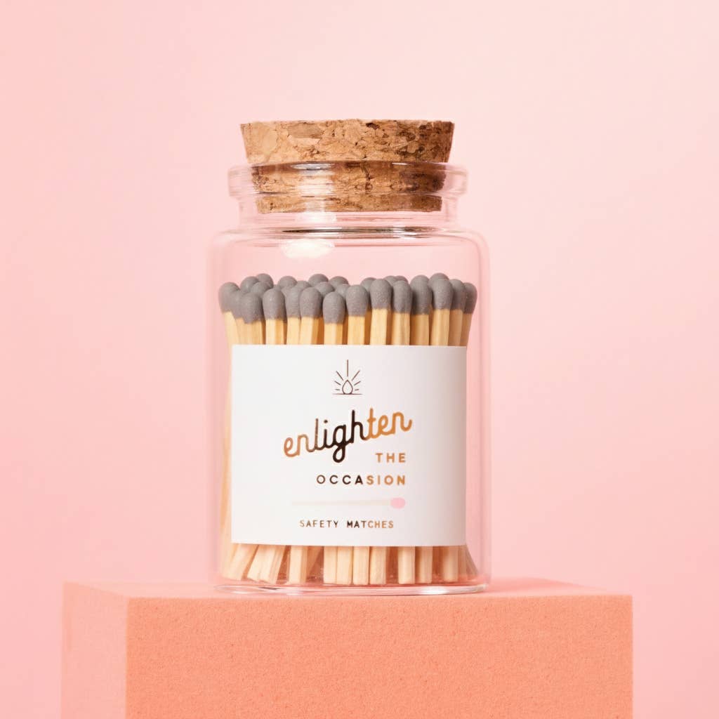 Jar of matches with a label on a pink background