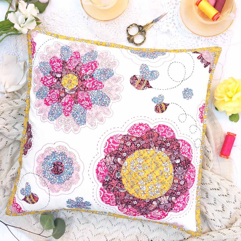 Decorative pillow with floral patterns on a table with sewing supplies