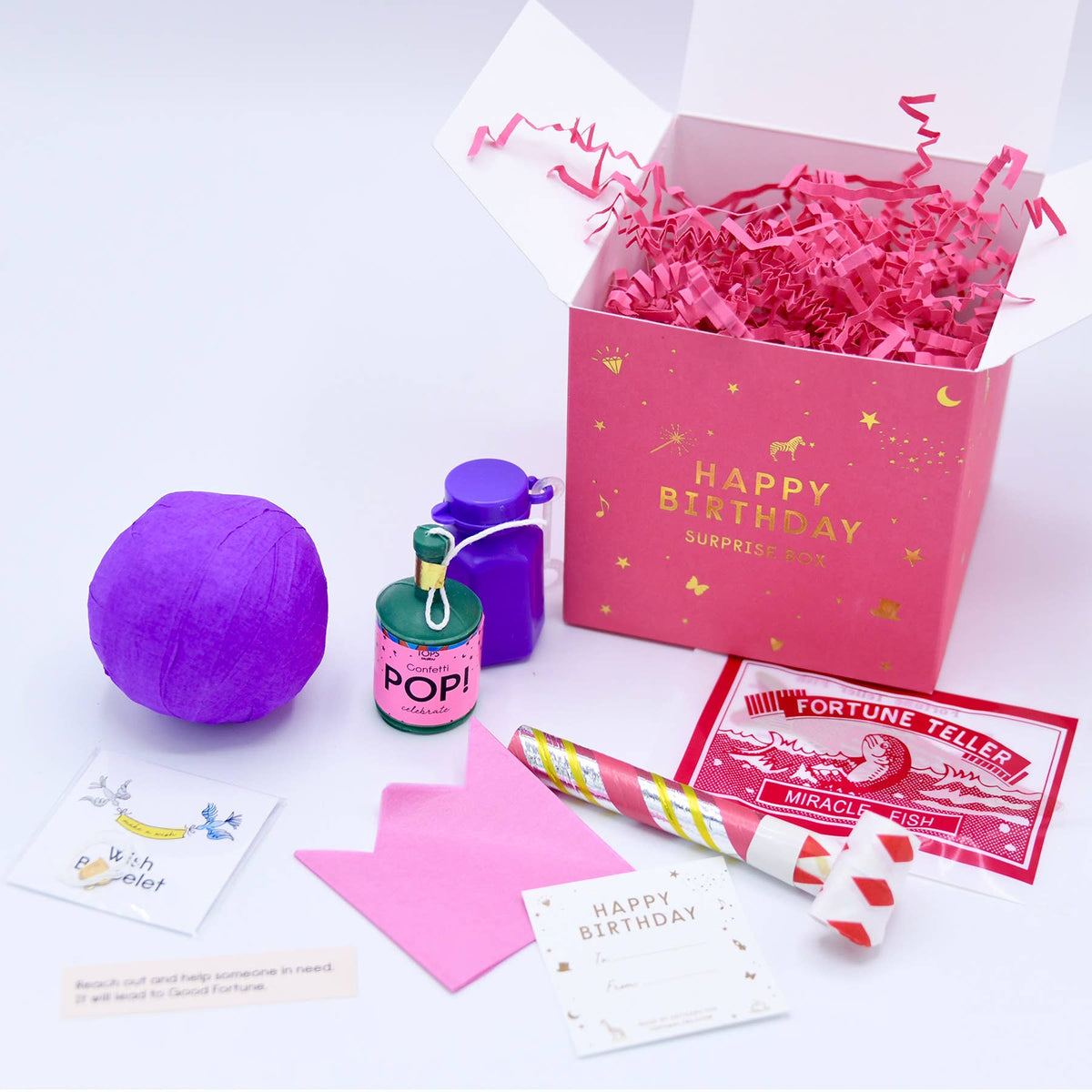 Birthday-themed items including a purple ball, water bottle, and box with pink interior on a white background.