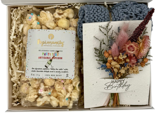 Gift box with popcorn, flowers, and a card inside