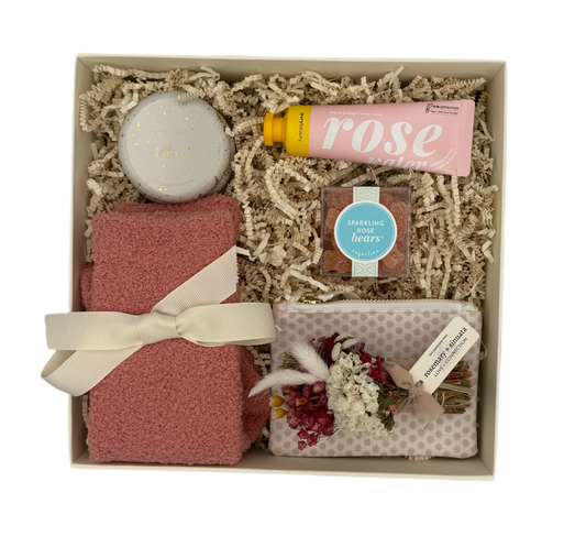 Gift set with a candle, soap, and other items in a box