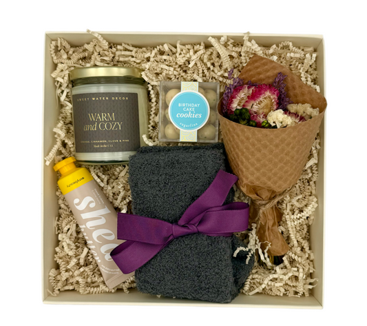 Warm + Cozy fall gift box with candle, socks, and dried flowers