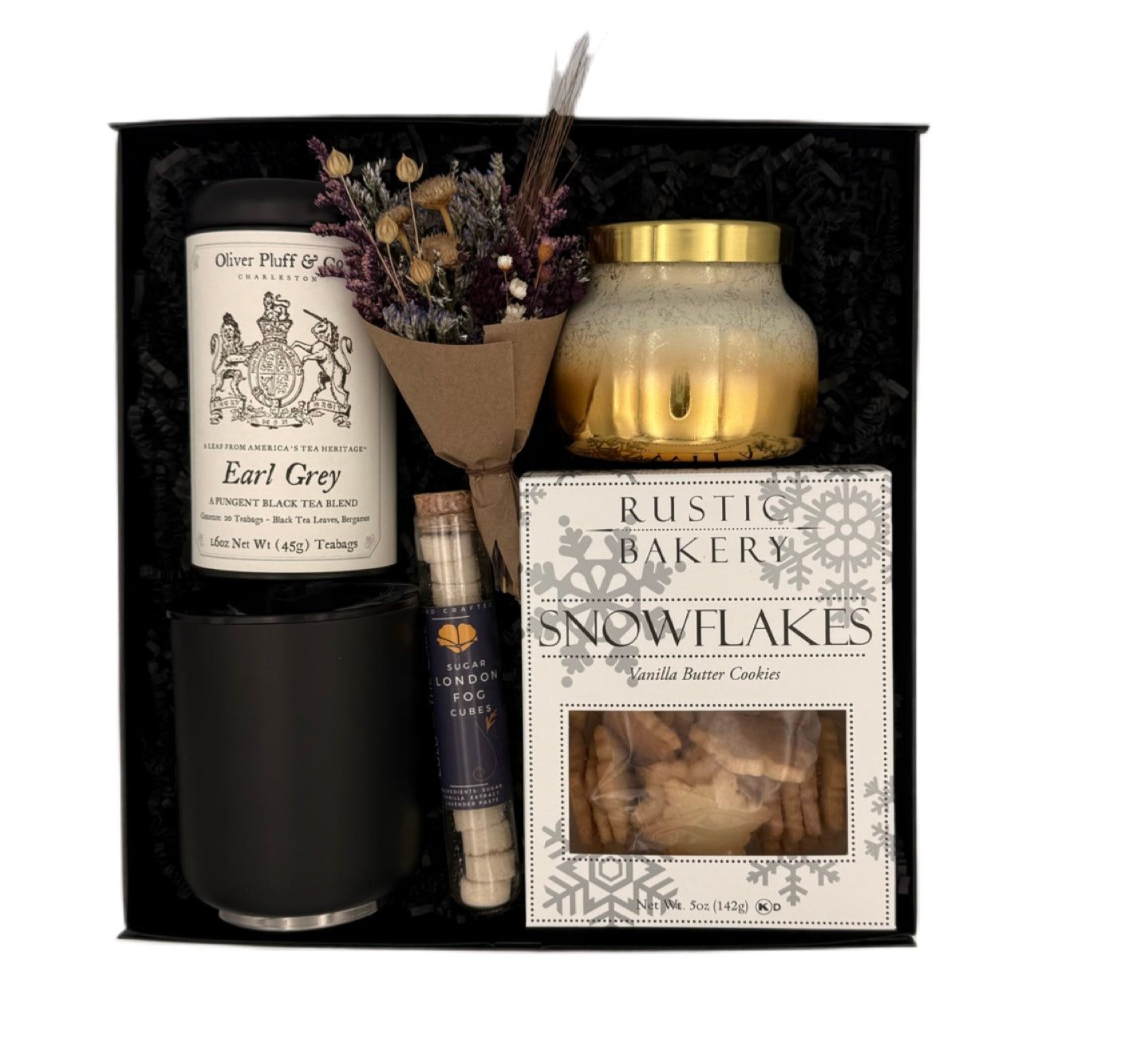 Gift set with tea, candle, and other items in a black box