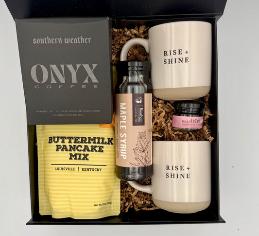 Gift set with mugs, coffee, pancake mix, and syrup in a box labeled 'southern weather ONYX COFFEE'.