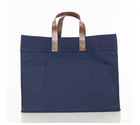 Navy tote bag with brown leather handles on a white background