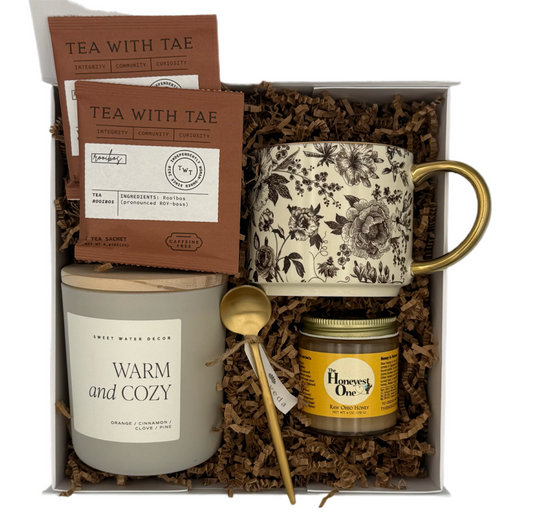 Gift set with mug, tea packages, candle, and jar in a box