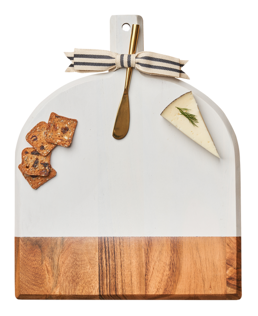 White marble cutting board with wooden bottom, gold spoon, and food items on a white background