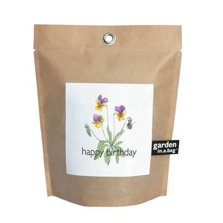 Kraft paper bag with a plant label and 'happy birthday' text on a white background