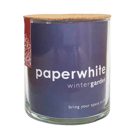 A glass jar candle with a purple label reading 'paperwhite wintergarden' and a light wood lid, shown on a plain white background.