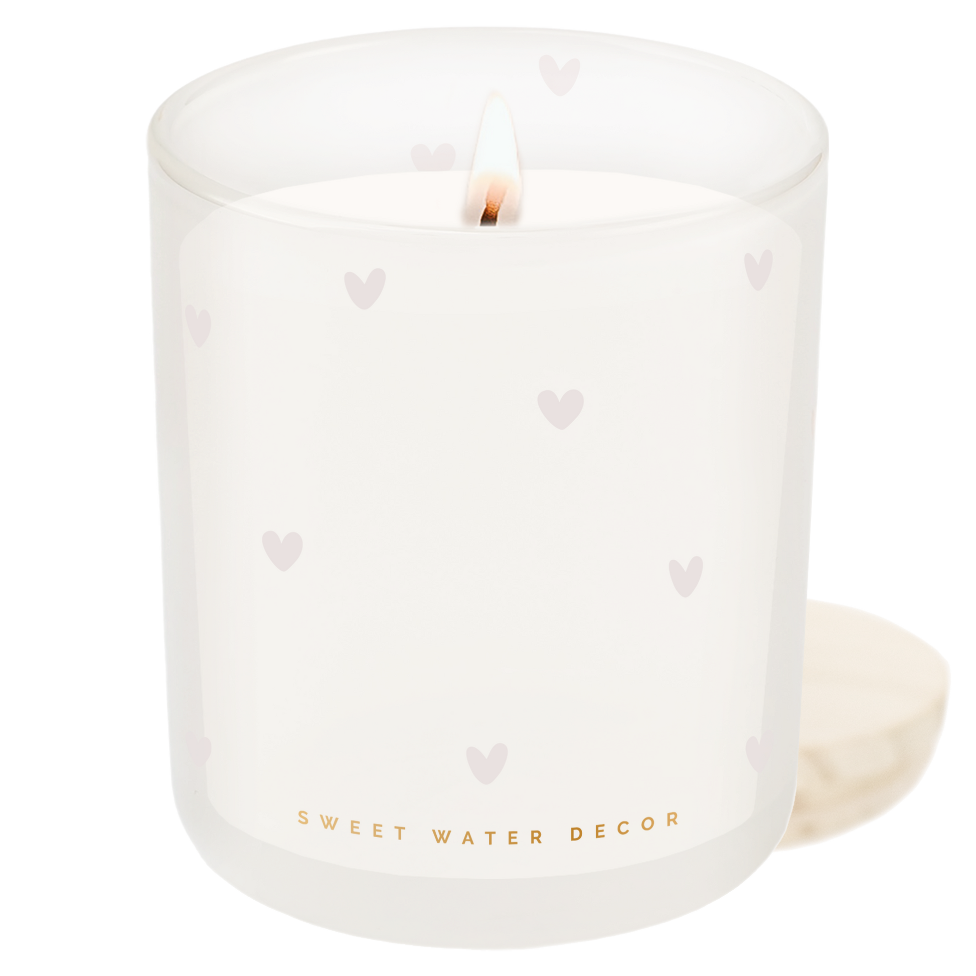 White candle with heart patterns and 'Sweet Water Decor' branding on a white background