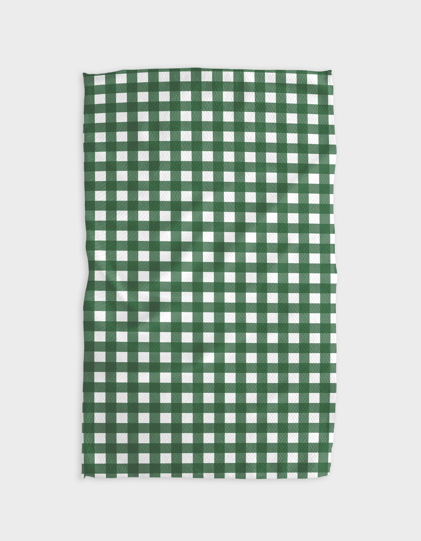 Green and white checkered fabric on a light gray background