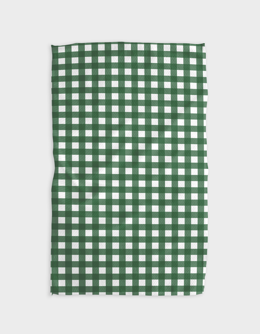 Green and white checkered fabric on a light gray background
