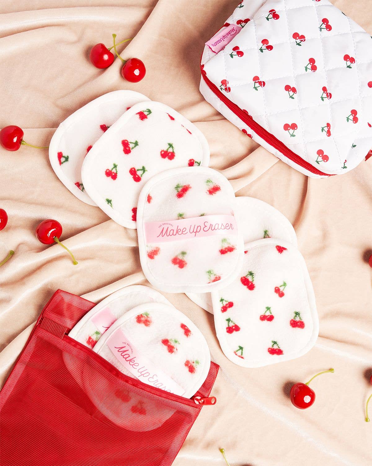 Make-up erasers with cherry design on a beige fabric background