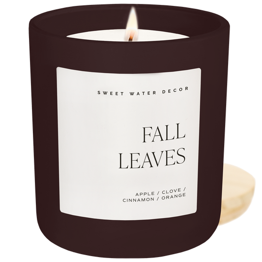 Candle with 'Fall Leaves' label and 'Sweet Water Decor' branding on a white background