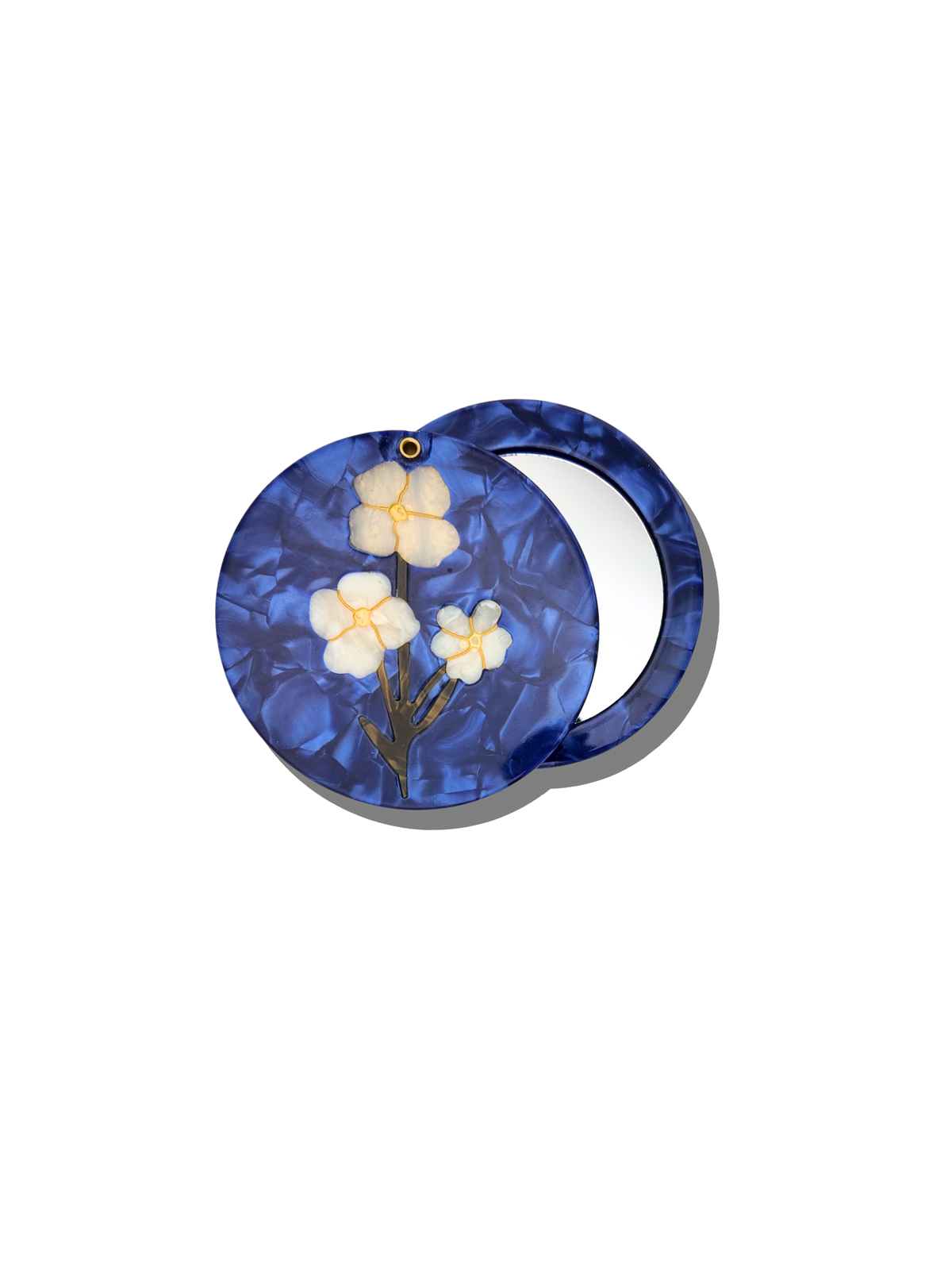 Blue circular mirror with floral design on a white background