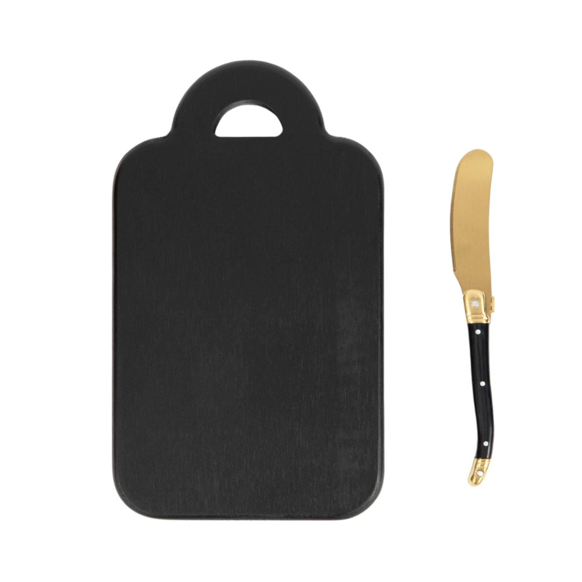 Black cutting board with a gold butter knife on a white background