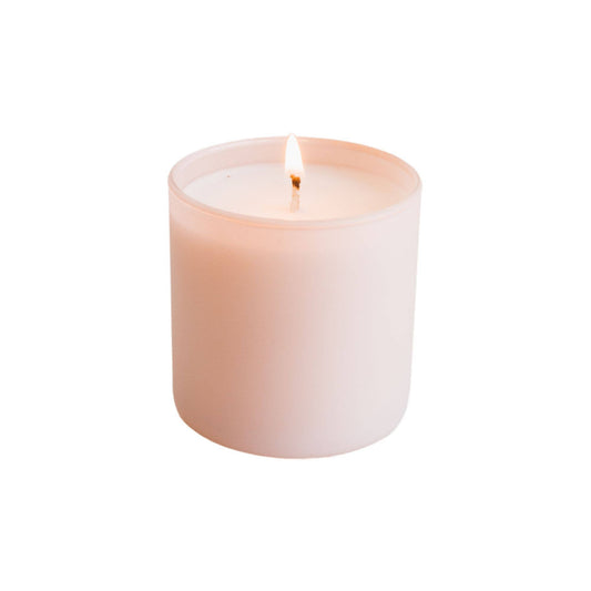 Pink candle on a white background