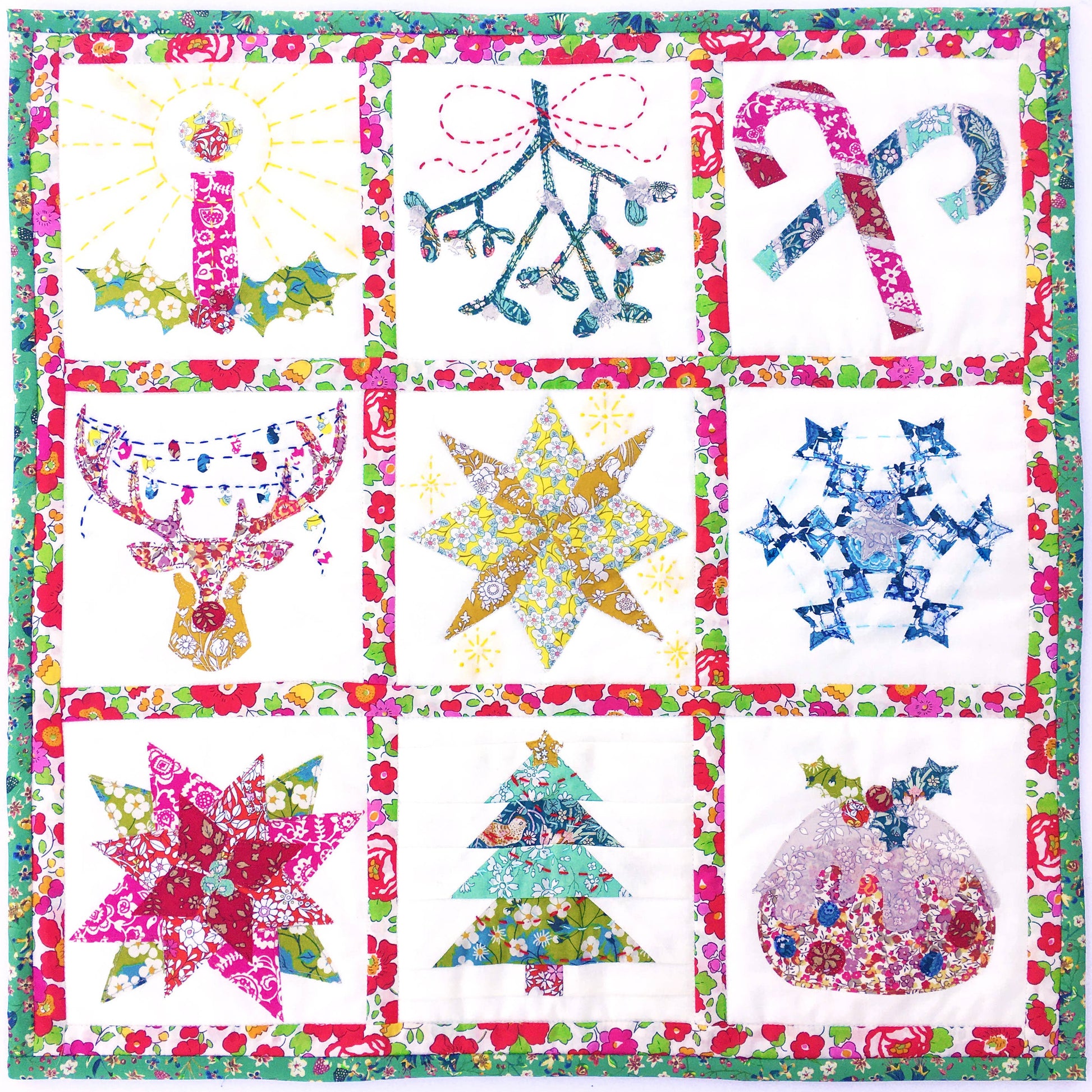 Colorful quilt with various festive patterns including stars, trees, and candy canes.