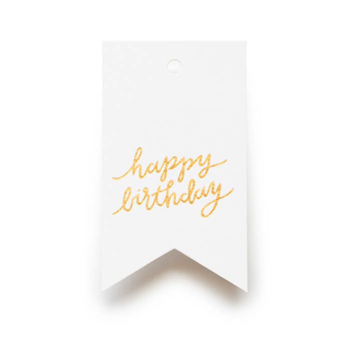 White card with 'happy birthday' in gold on a white background