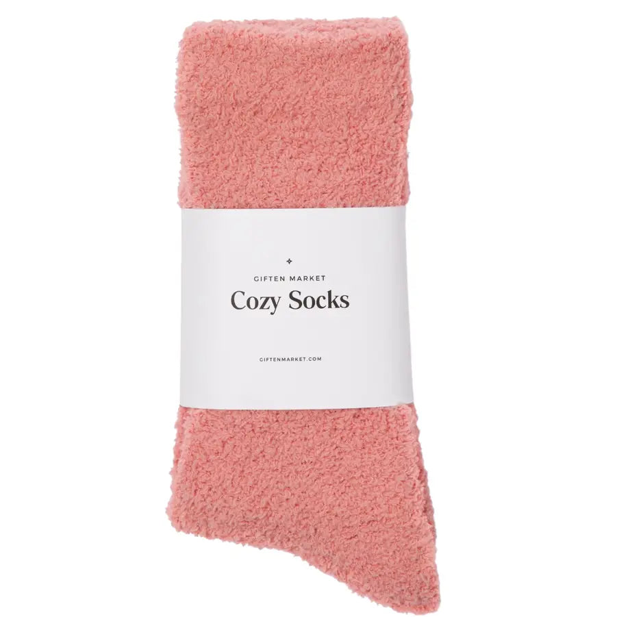 Pink cozy socks with a white label on a white background