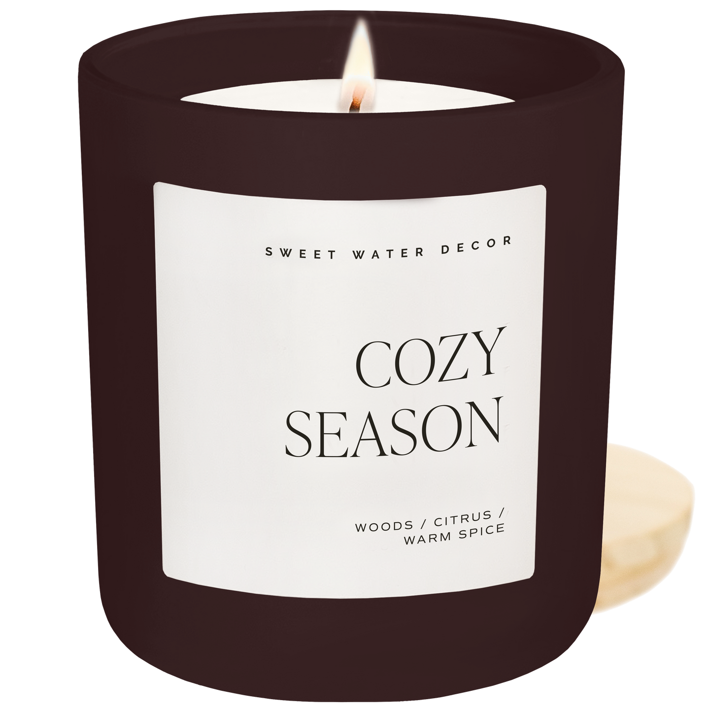 Candle with 'Cozy Season' label on a white background