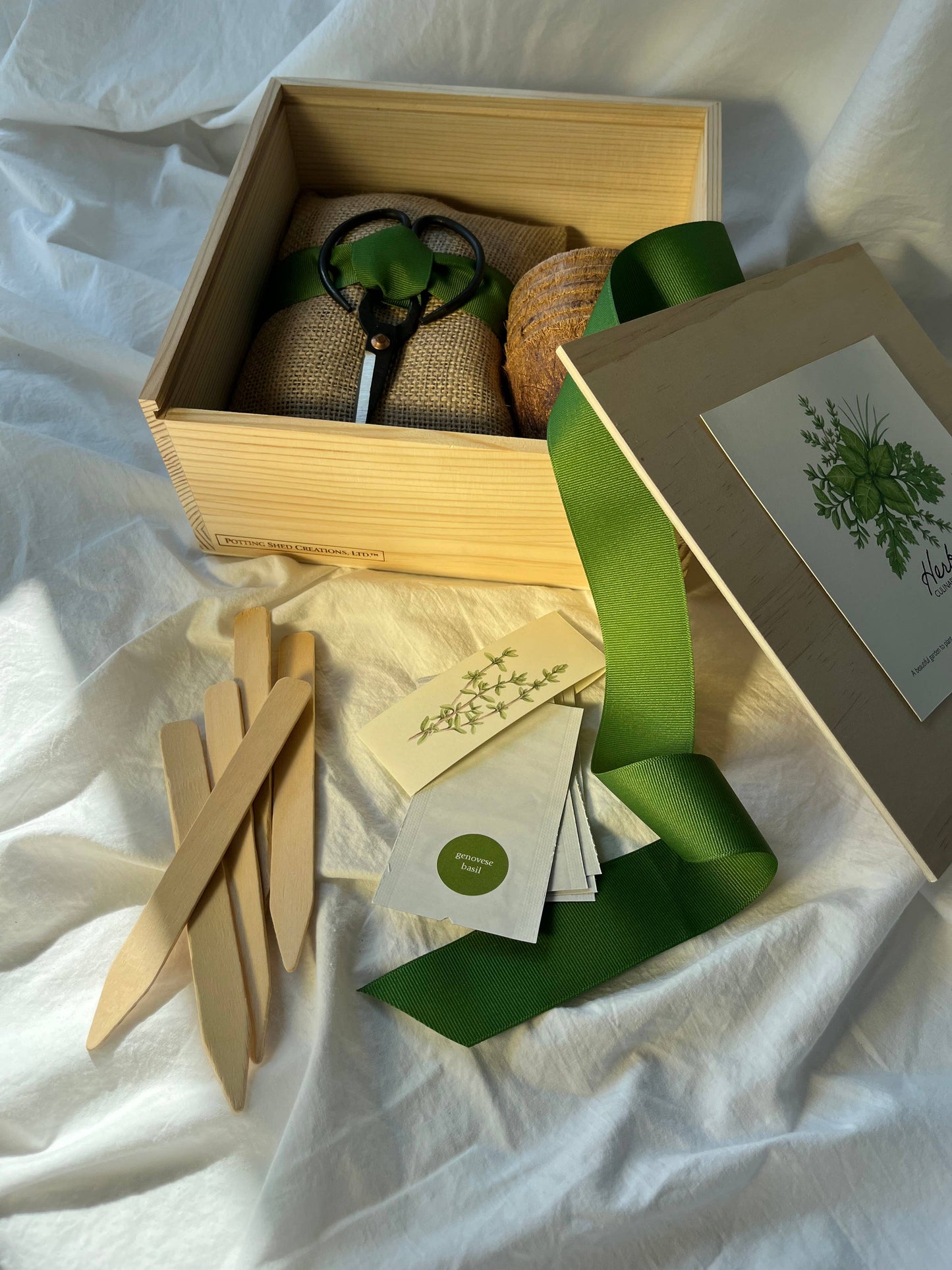 Gardening kit with tools and supplies on a white fabric background