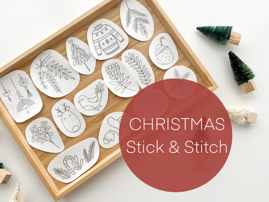 Wooden tray with Christmas-themed stick and stitch patterns on a white background.