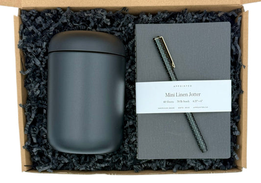 Set of gray mug, notebook, and pen in a gift box