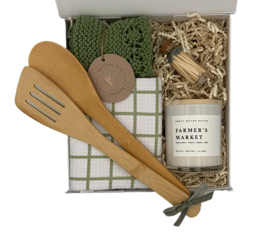Gift set with wooden utensils, candle, and towel in a box
