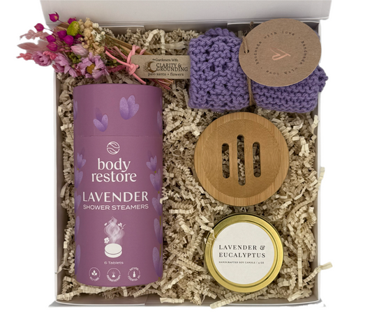 Gift set with lavender-themed products including a canister, soap, and candle in a box.