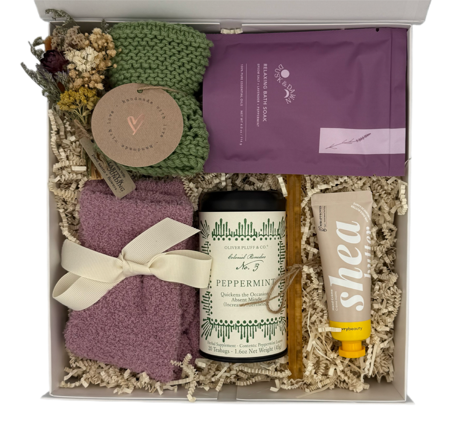 Gift set with a candle, soap, and other items in a box