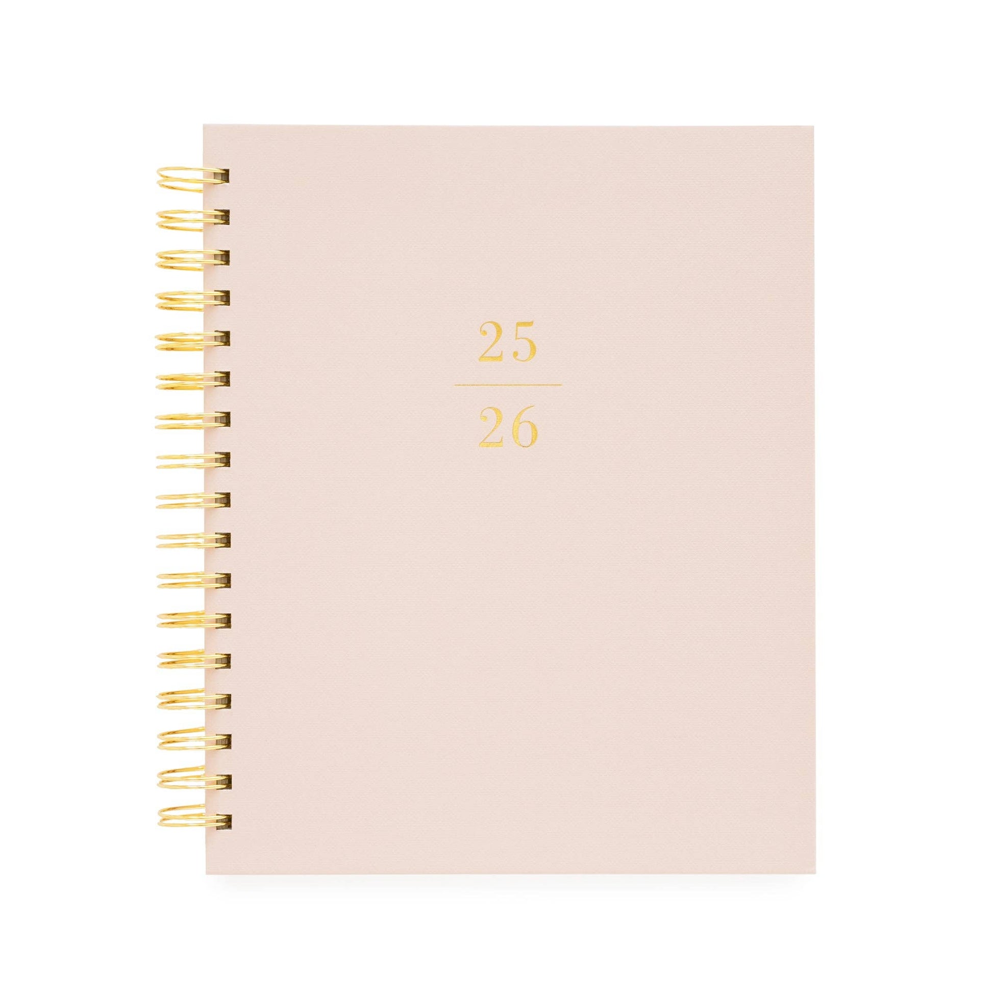 Blush pink planner with gold spiral binding on a white background