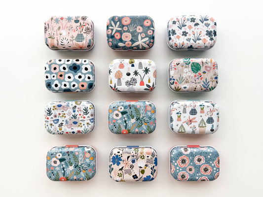 Grid of small rectangular containers with floral patterns on a white background