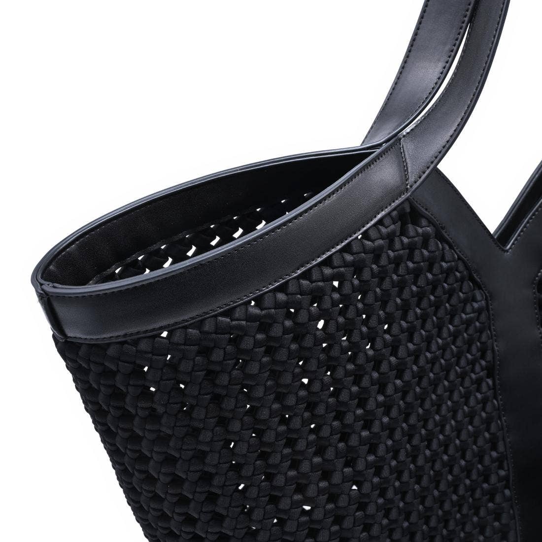 Black woven handbag with a smooth handle on a white background
