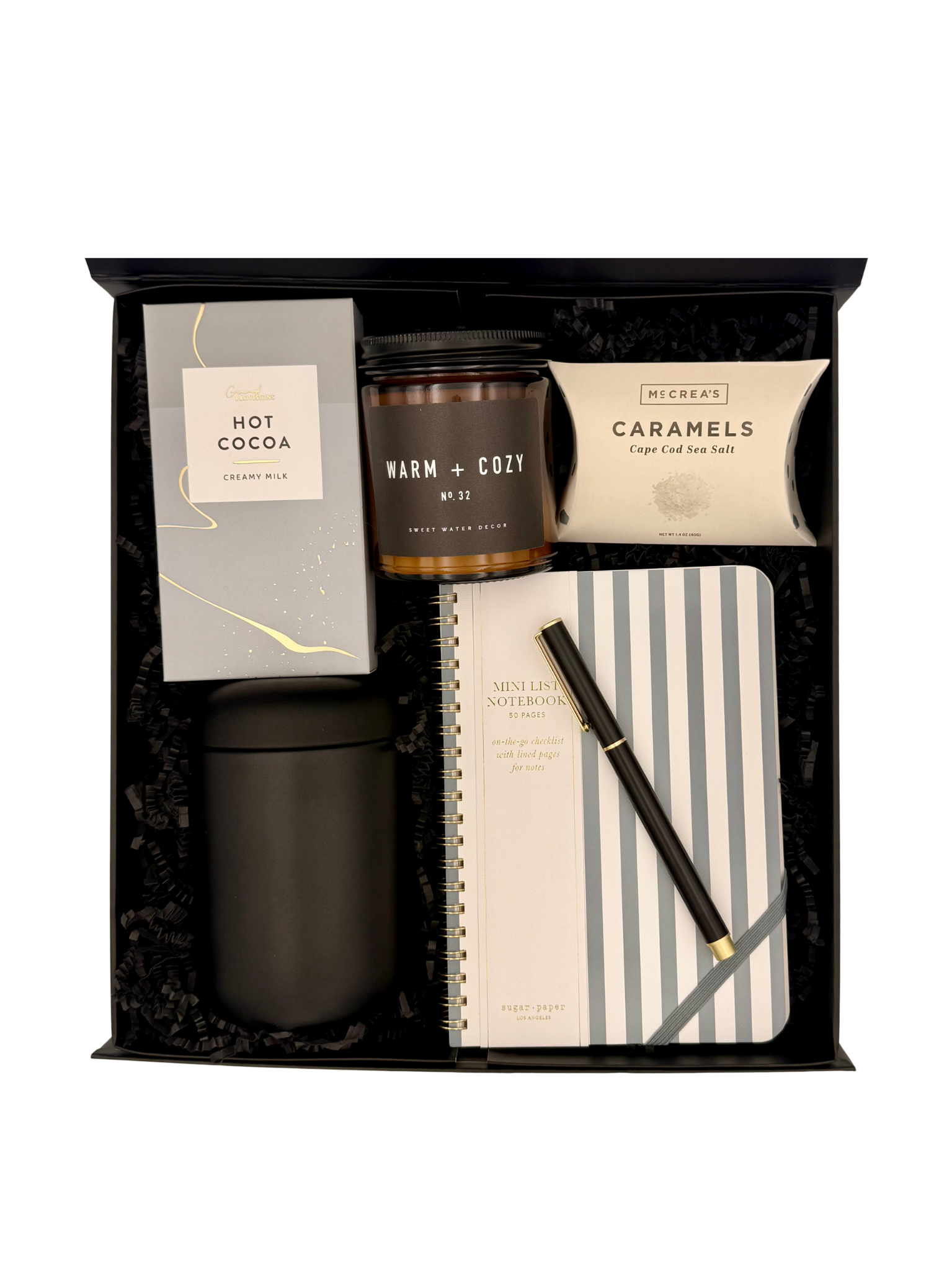 Gift set with candles, notebook, and pen in a black box
