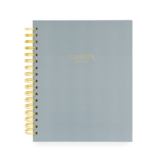 Gray planner with gold spiral binding on a white background