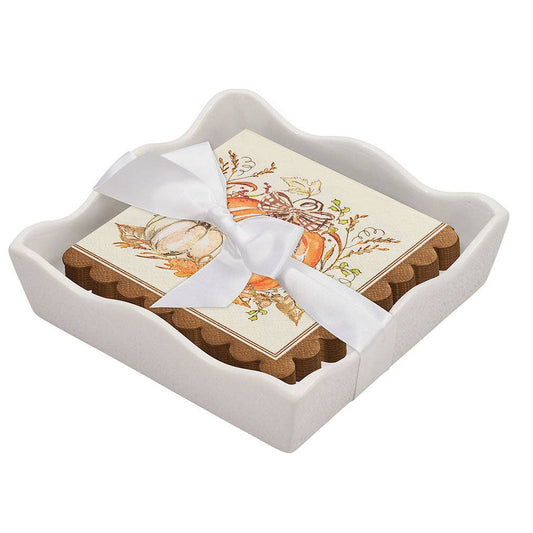 Set of coasters with decorative design in a white ceramic holder on a white background