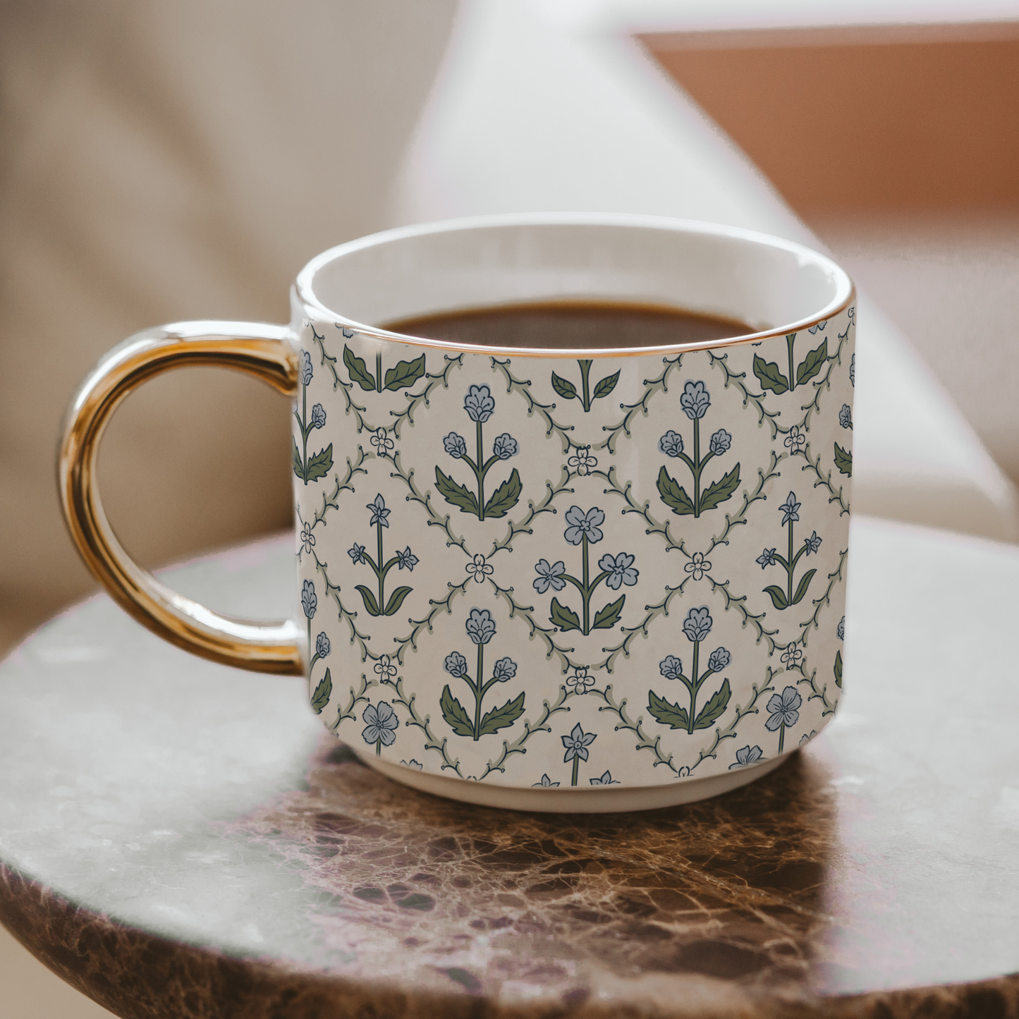 Patterned mug with floral design on a marble surface
