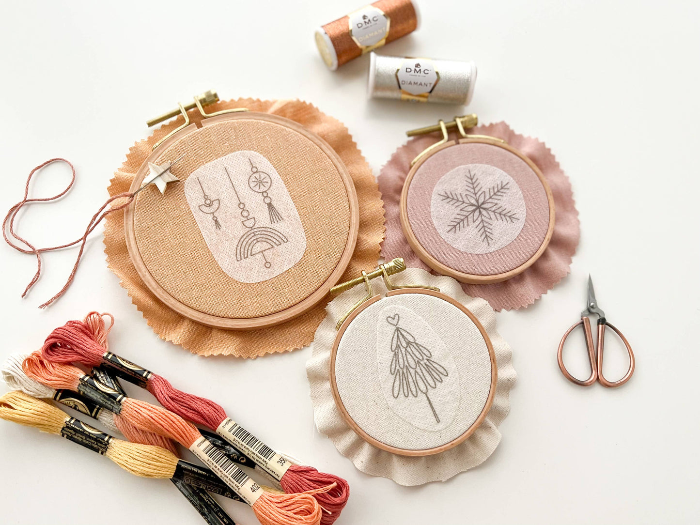 Embroidery hoops with completed designs on a white background