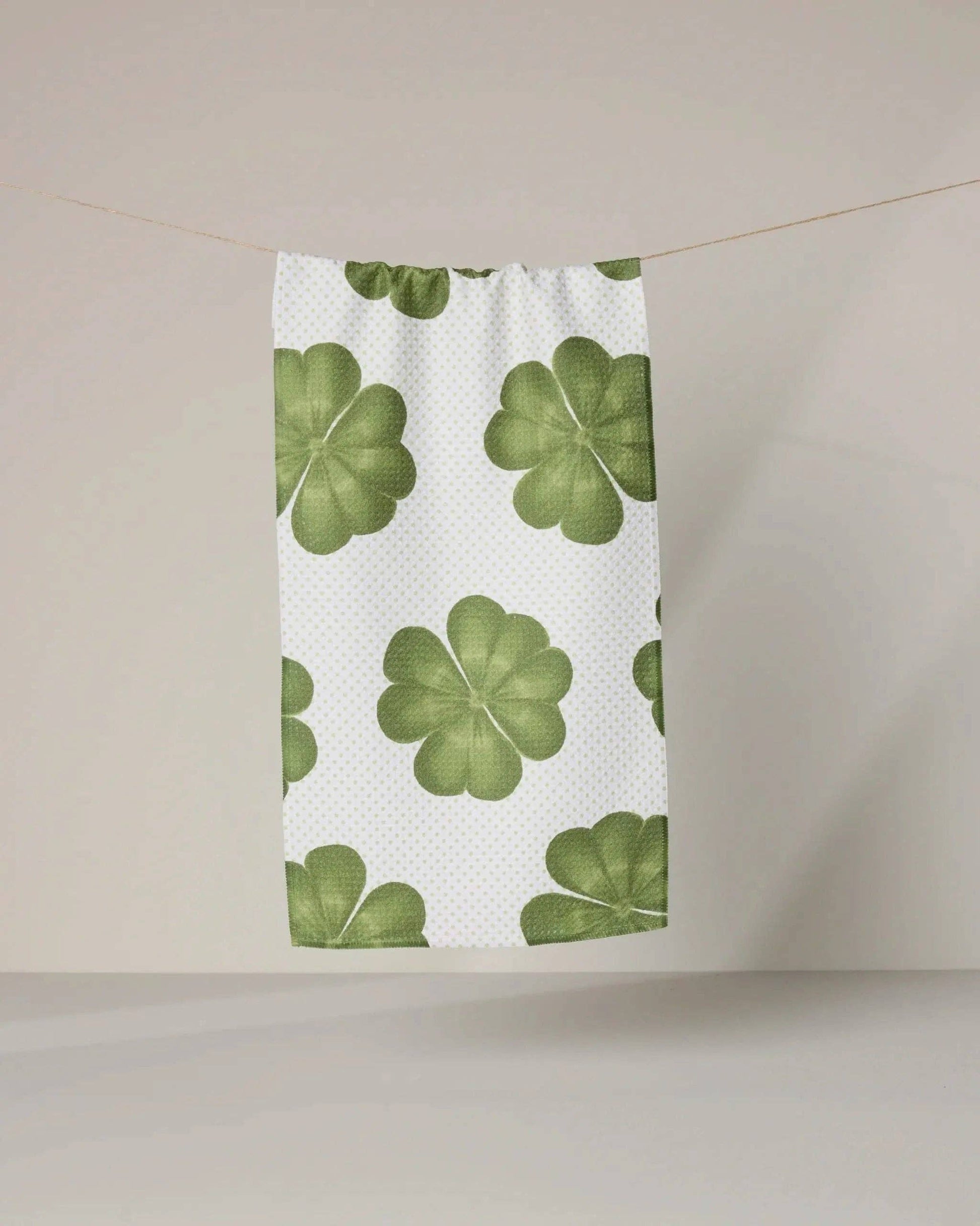 Green four-leaf clover pattern on a white background