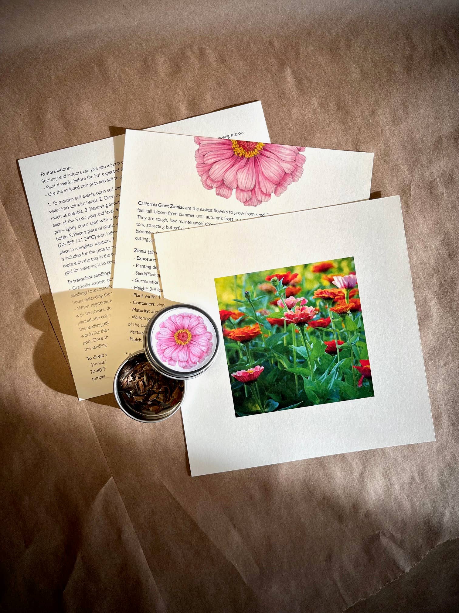 Floral stationery set with pink flower stamp, card, and photo on brown fabric background