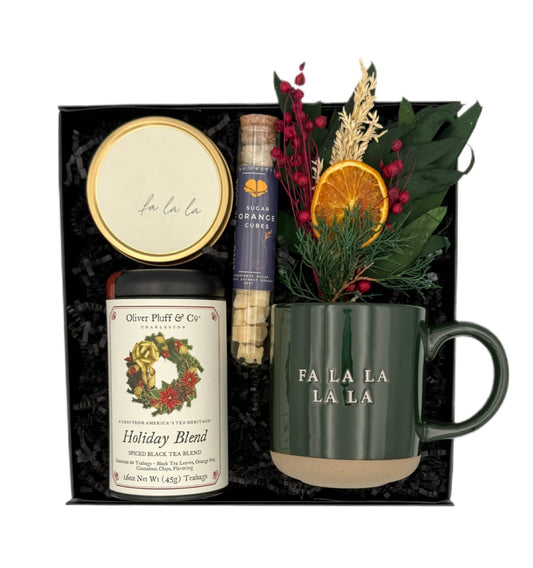 Holiday gift set with mug, tea, and decorative elements in a box