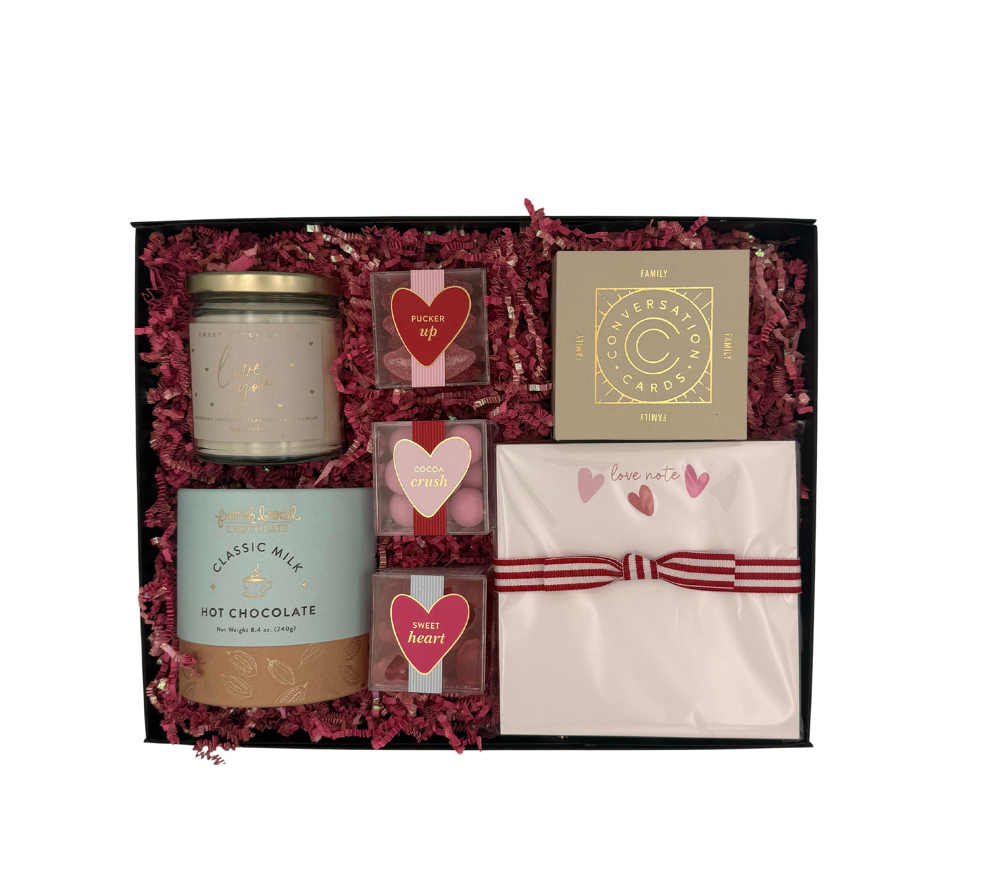 Gift set with candles, cards, and a letter in a decorative box