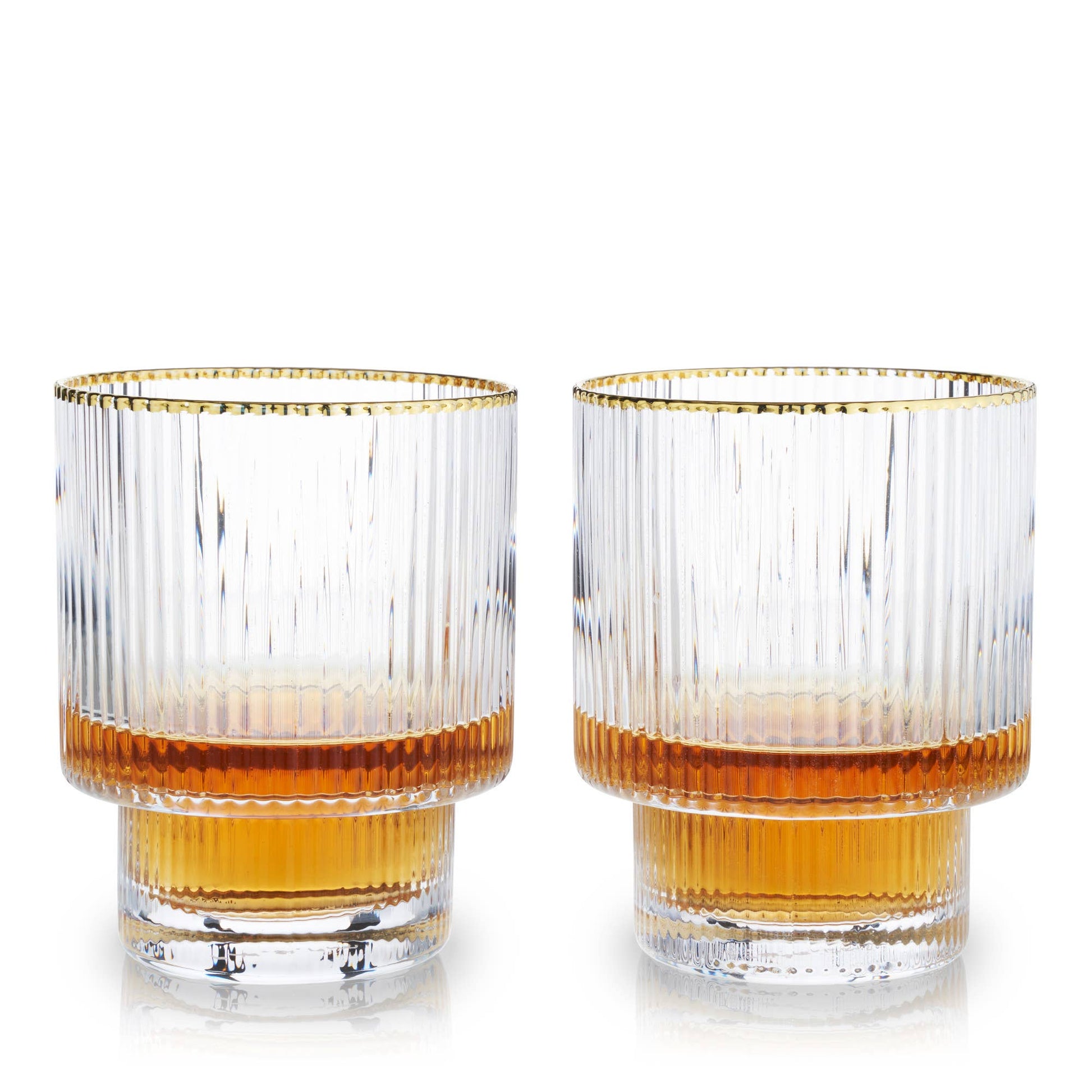 Two glasses with gold rims and orange liquid on a white background