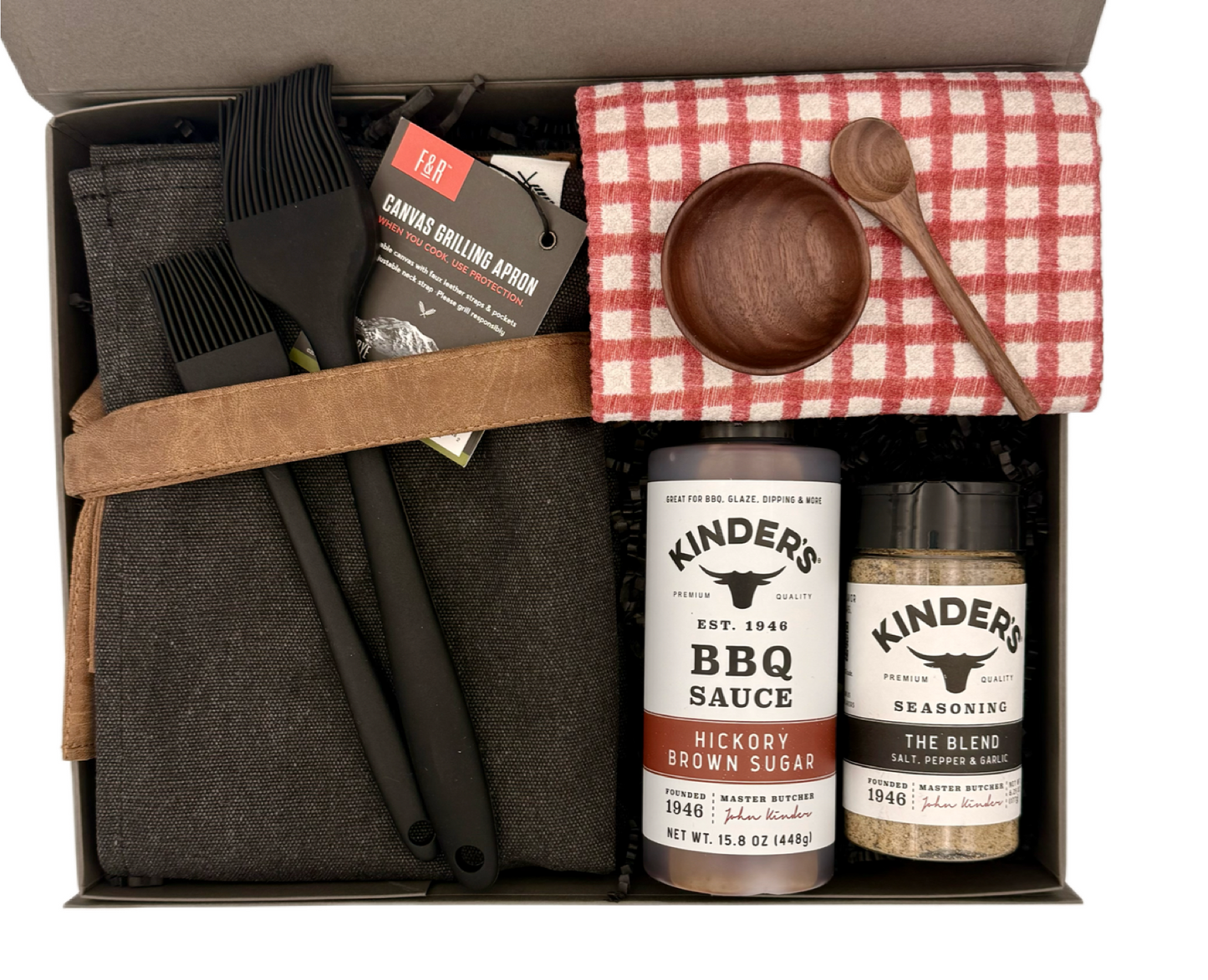 Grilling gift set with barbecue tools, sauces, and seasonings in a box.