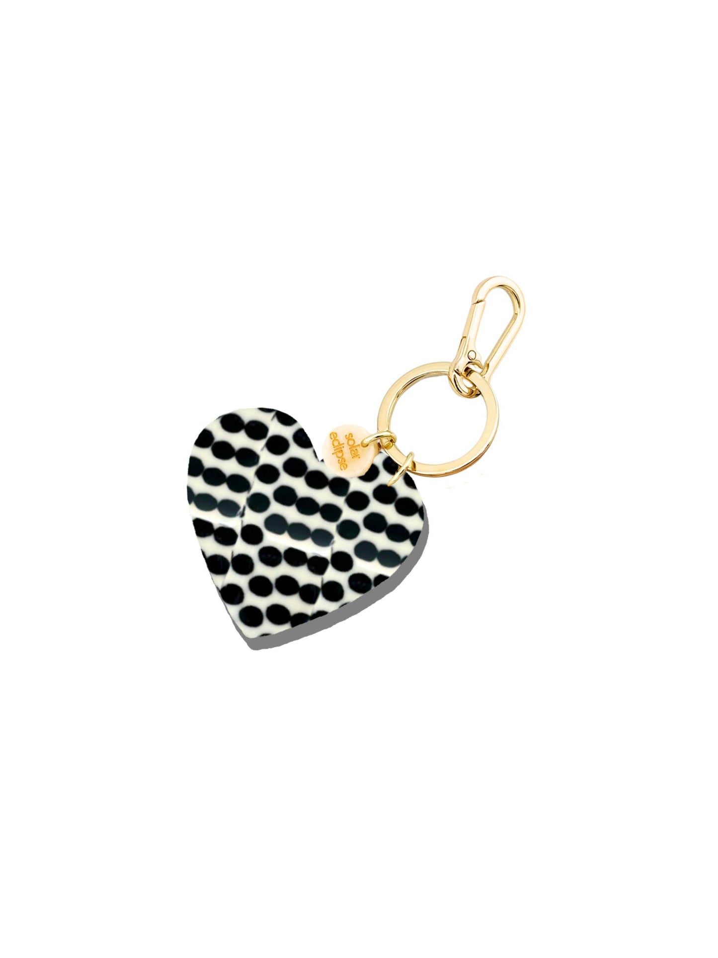 Heart-shaped keychain with black and white pattern on a white background