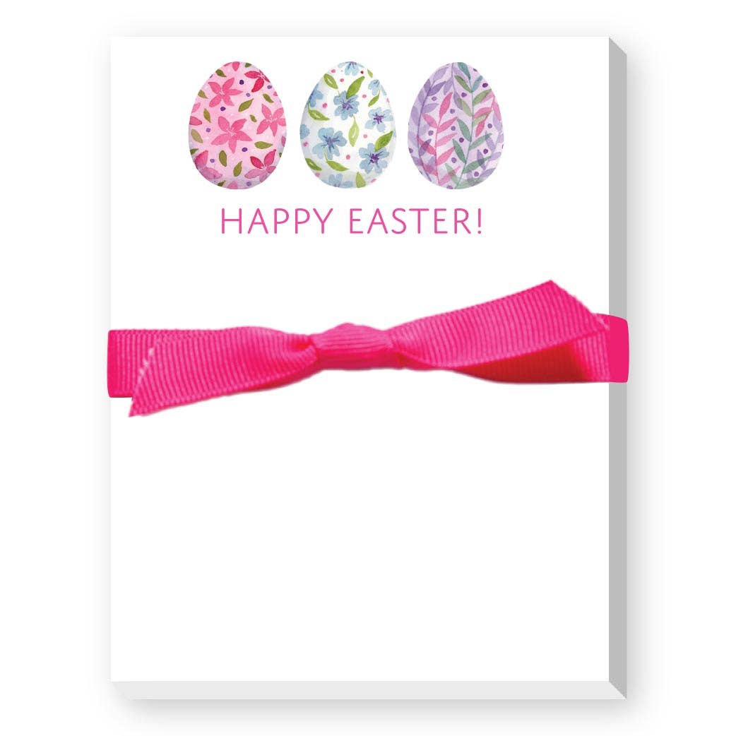 Notepad with floral Easter egg designs and a pink ribbon on a white background