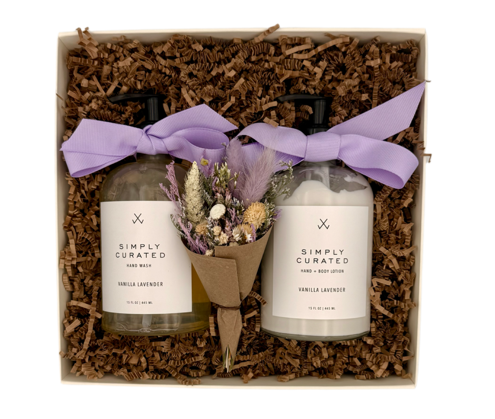 Two bottles of 'Simply Curated' body wash and lotion with a small bouquet of lavender in a decorative box.